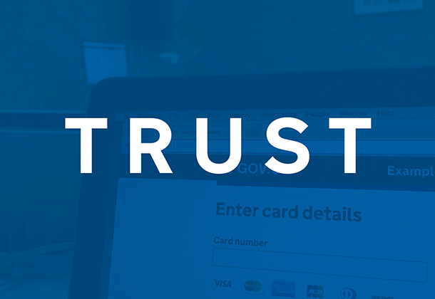 Image with the word 'Trust' on it and a greyed-out photo of a screen in the background with the words 'Enter card details' on.