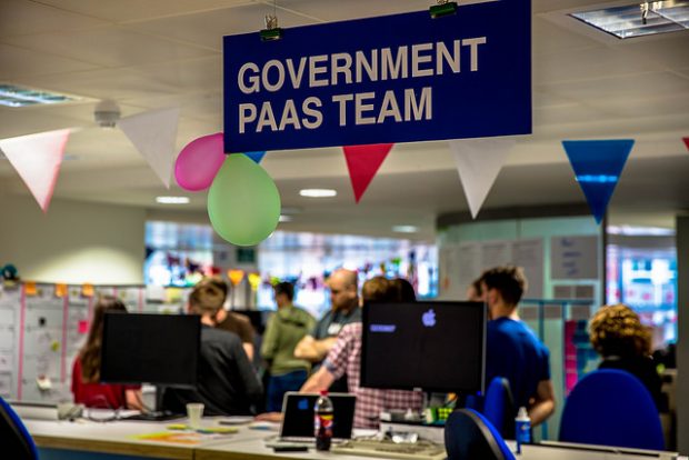 Platform as a Service team sign with people standing nearby