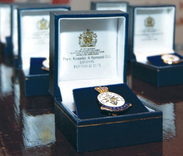 A medal in its decorative box sits on a wooden table